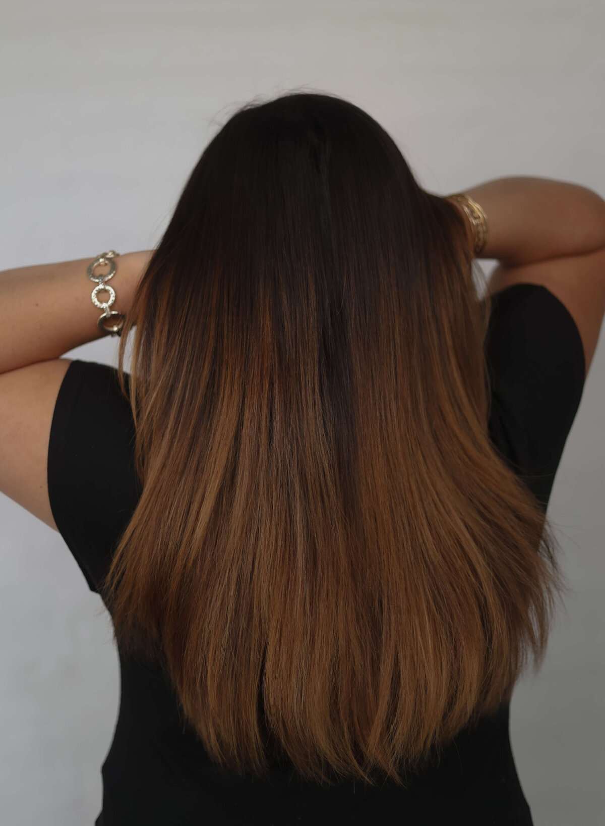 brunette women with new haircut showing back of her hair