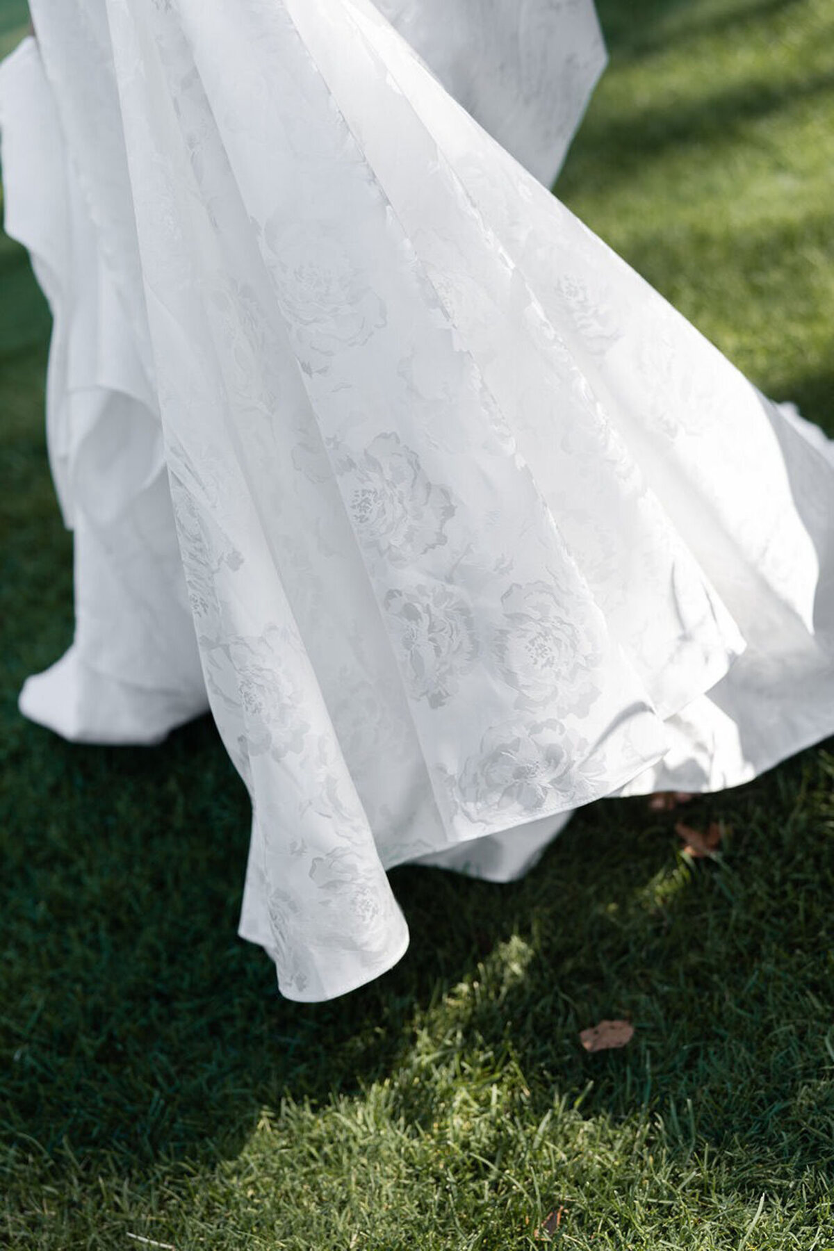 Wedding dress on grass, taken by wedding photographer in Cincinnati, OH