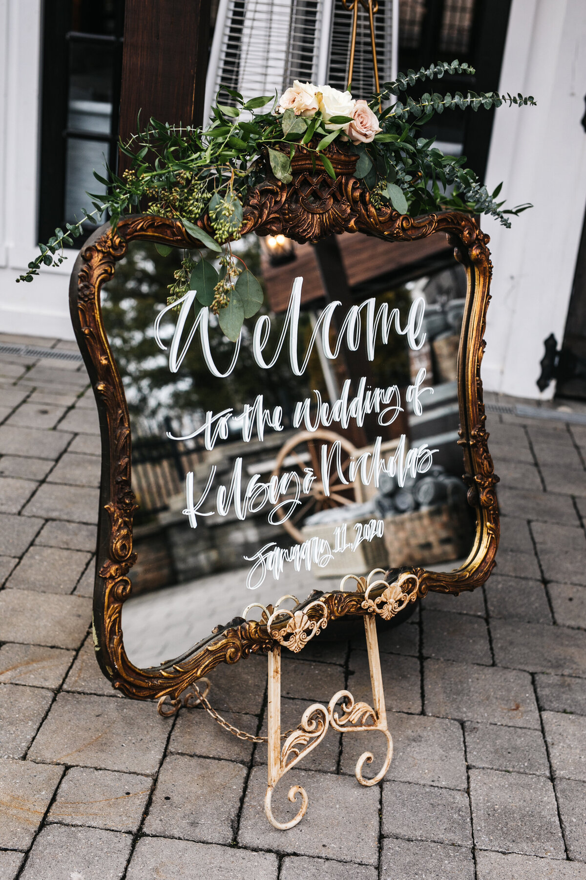 Ornate antique gold framed mirror welcome sign for a romantic wedding.