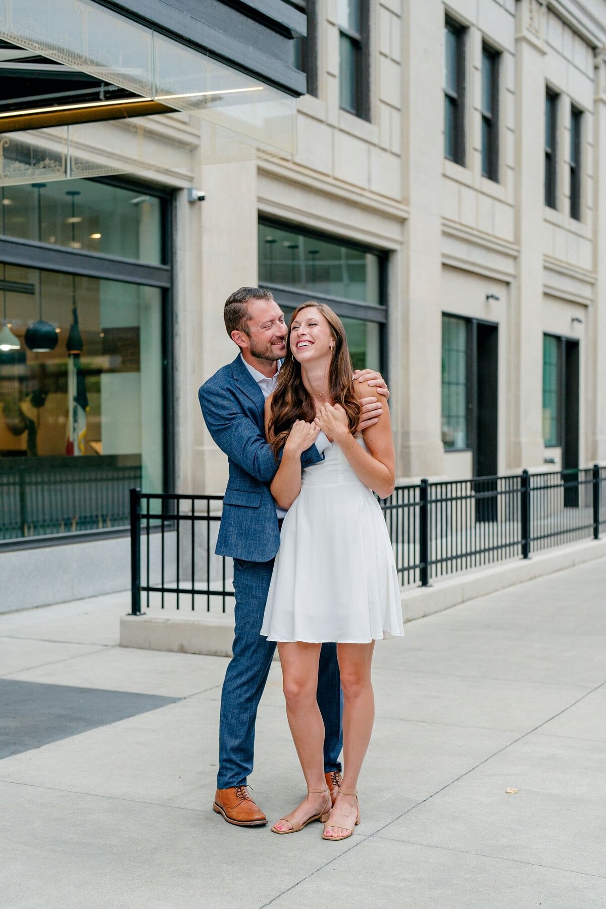 couple-holding-hands-smiling-downtown