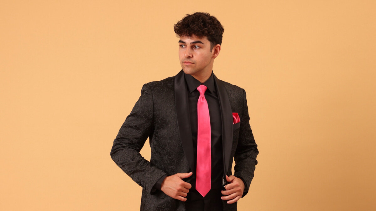 A young man in a black prom suit