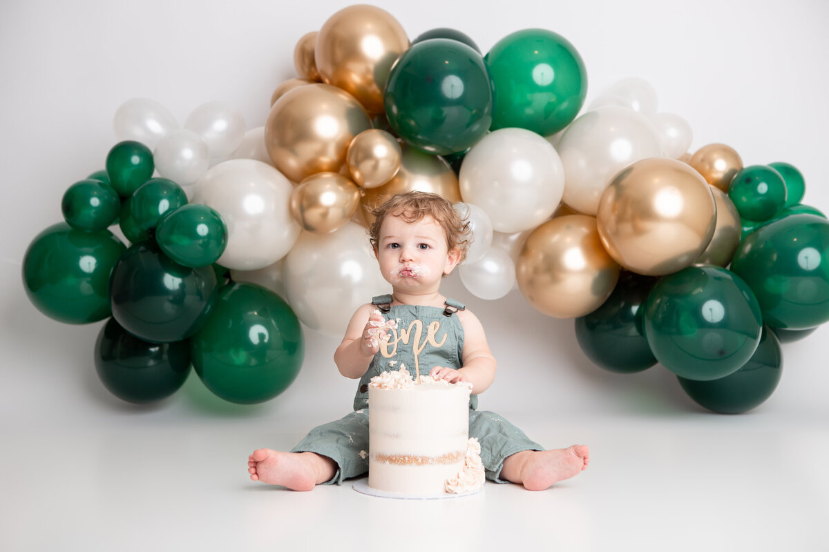 Edmonton baby boy first birthday cake smash green gold white balloon garland