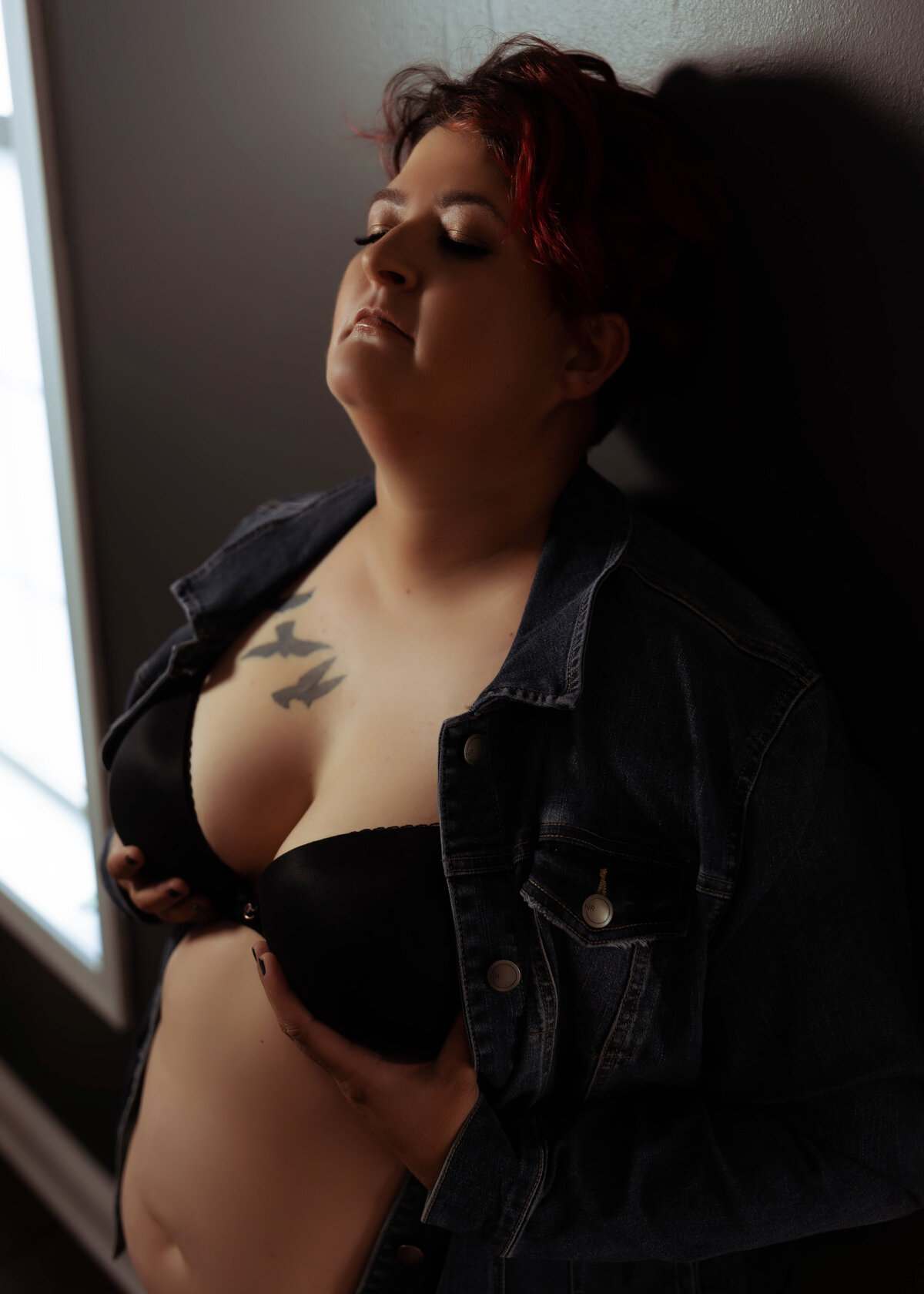 close up boudoir photo of woman with short hair in leather jacket and bra elkridge