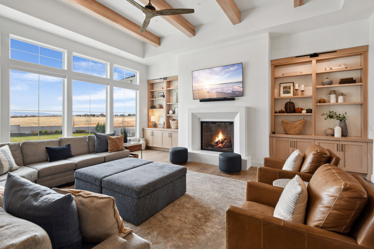 Custom great room with fireplace and wooden beams by Idaho luxury custom home builder Thompson Homes