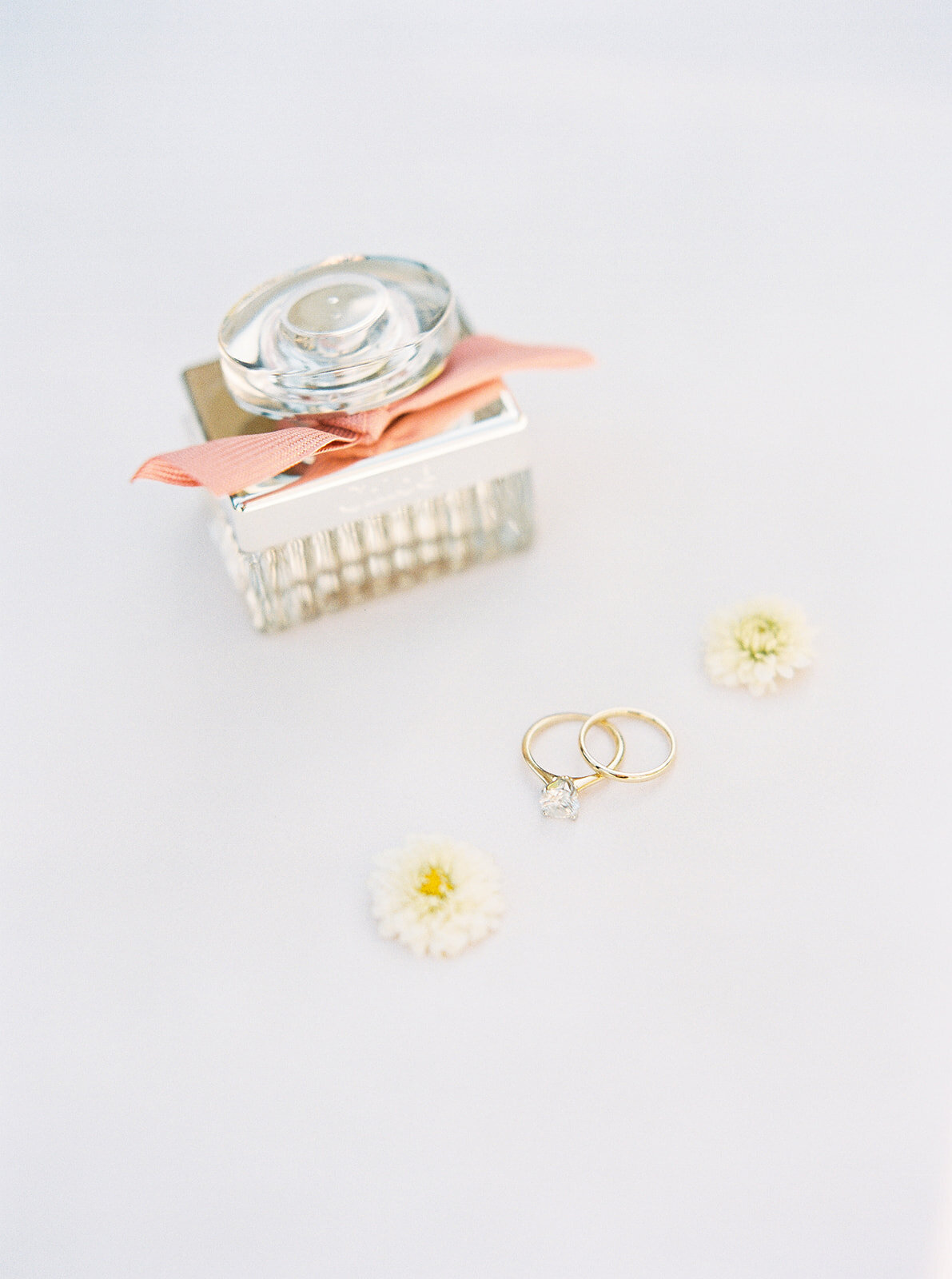 wedding rings with flowers and other bridal accessories
