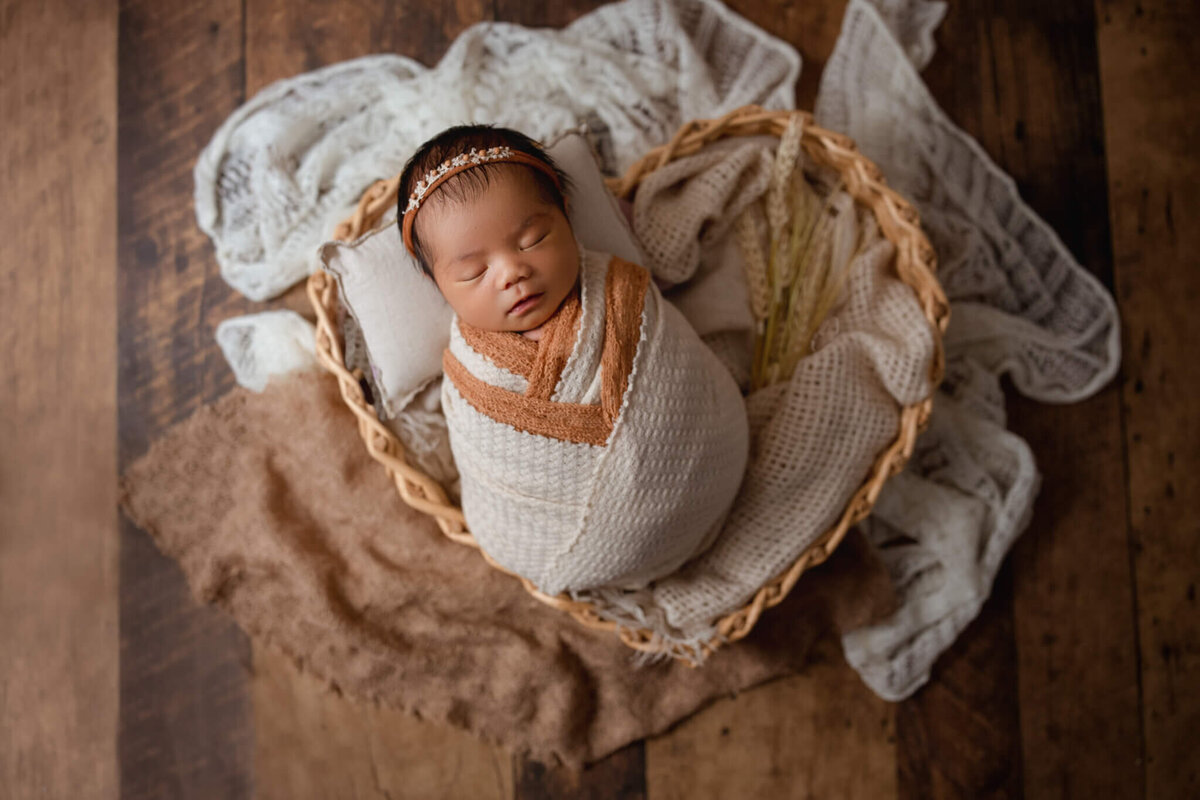 newborn baby wrapped up and placed in bamboo heart basket, niagara , ON