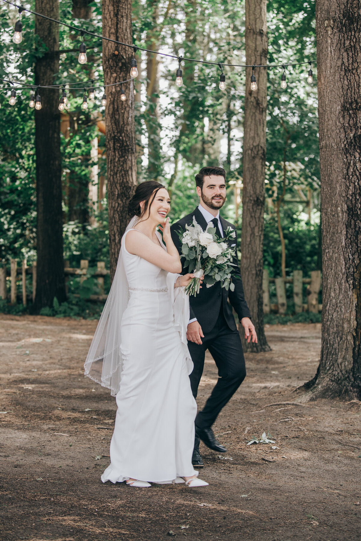 A wedding day first look between a bride and groom in an enchanted forest