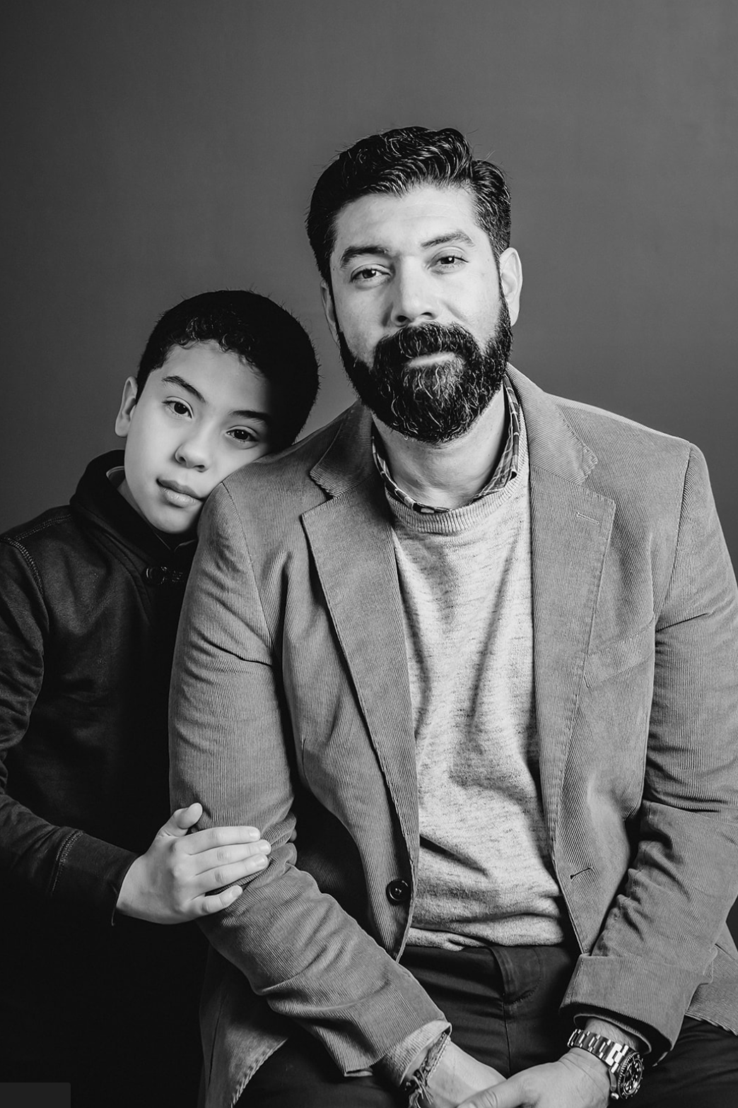 Black and white portrait of father and son in smart attire