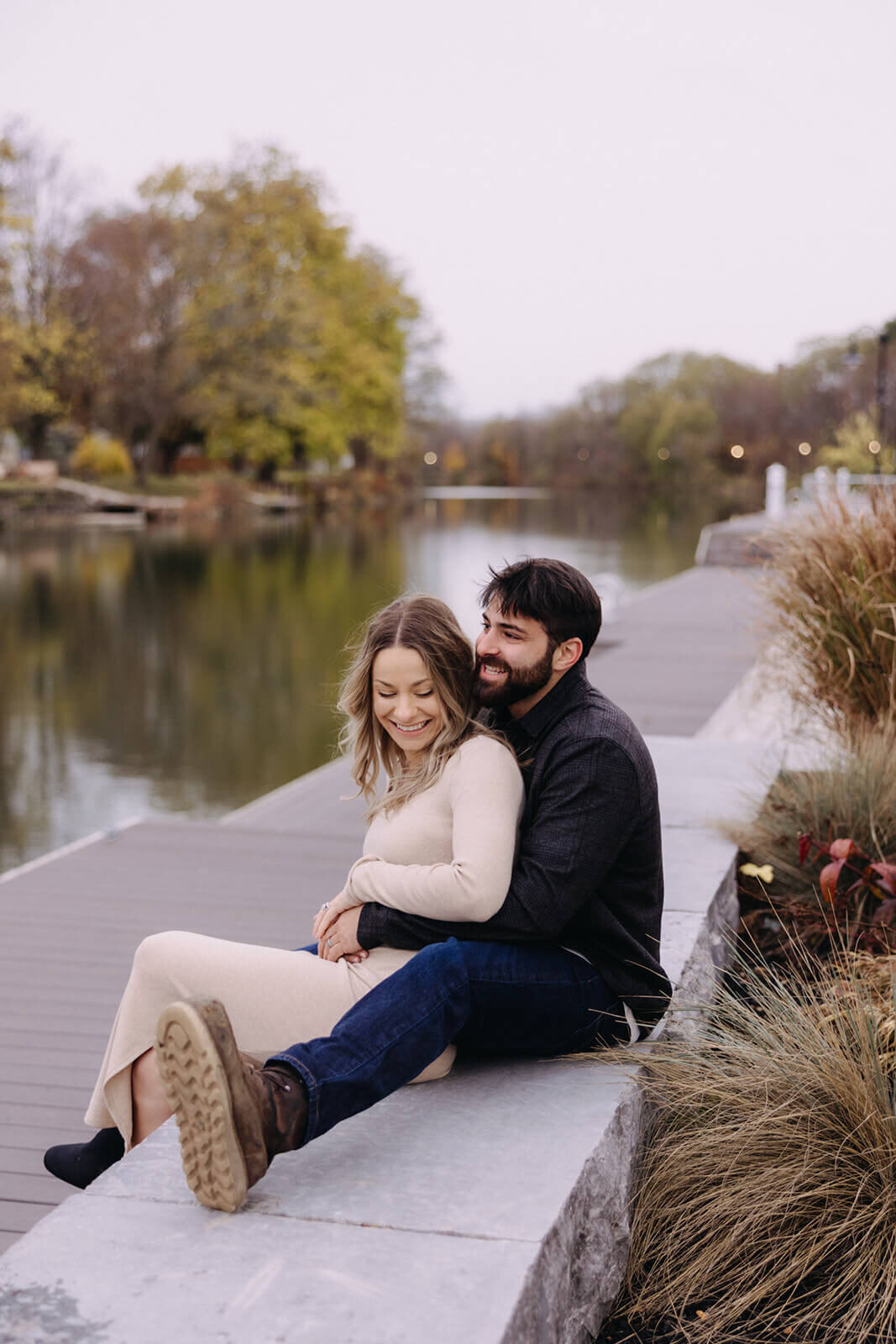Couple with arms wrapped around each other for at Finger Lakes maternity session