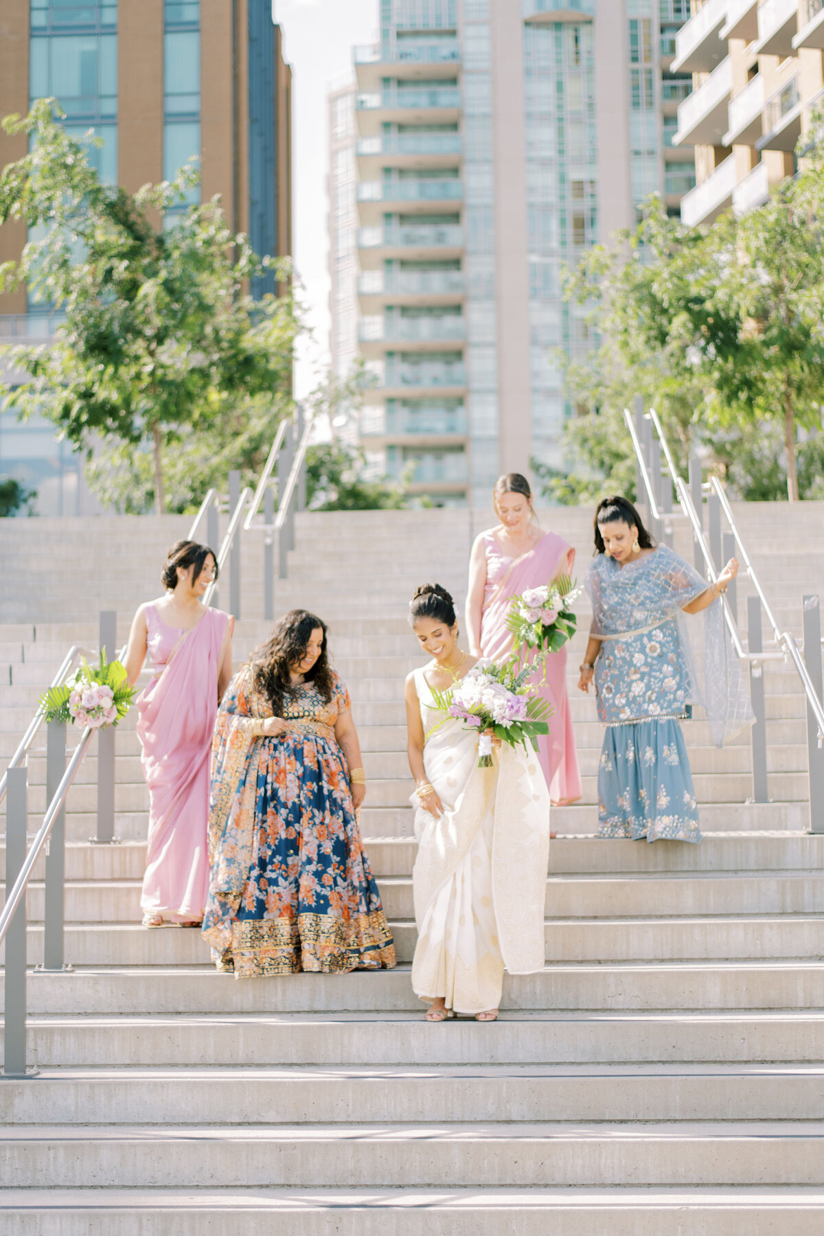 "Bridal party sharing a joyful moment, laughing together at The Pearle Hotel in Burlington during an Indian wedding.
