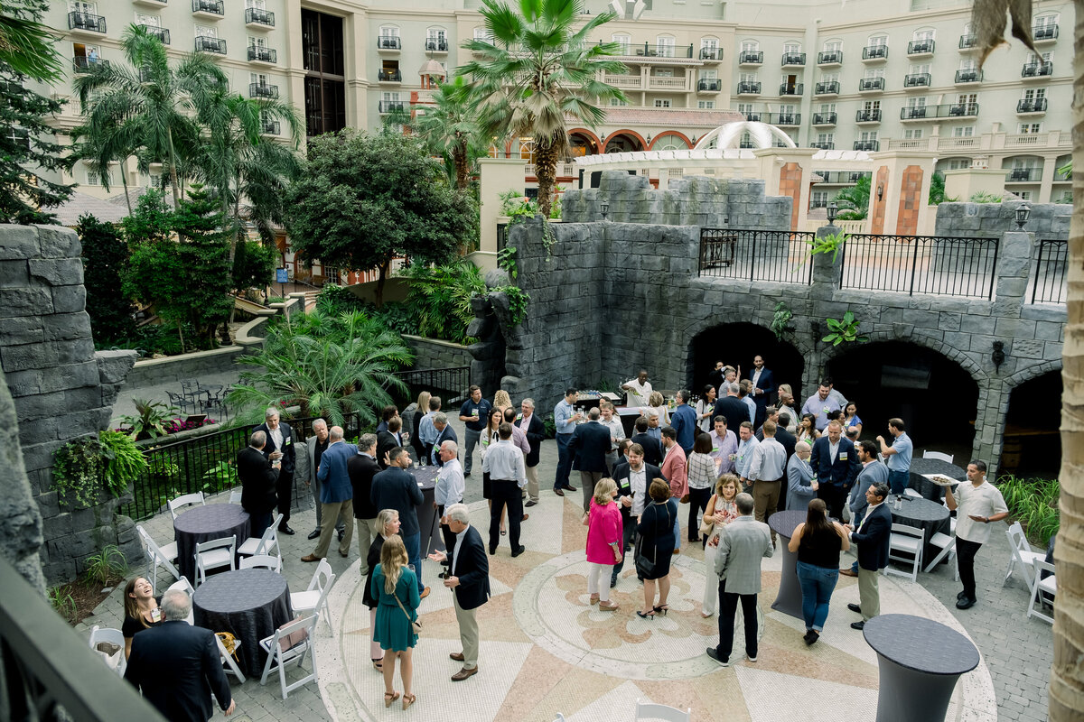 Summit attendants gather for social hour in the lobby of the Gaylord Palms in Orlando, Florida