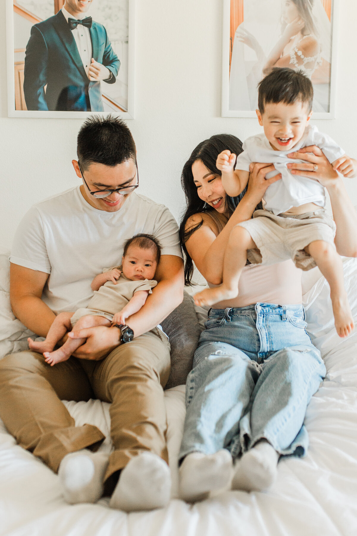 Family portrait on a bed, parents with two children
