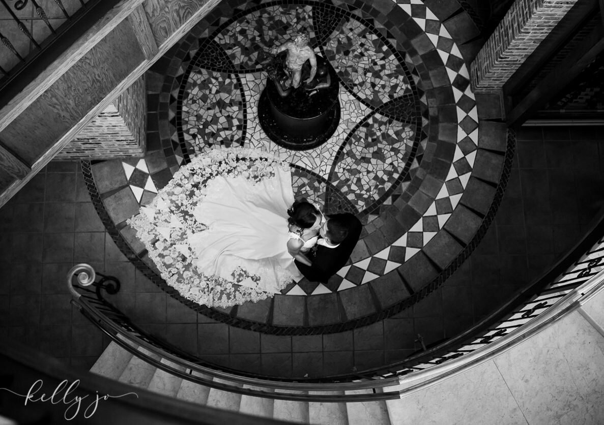 A bride and groom on a spiral staircase by a Grand Rapids wedding photographer