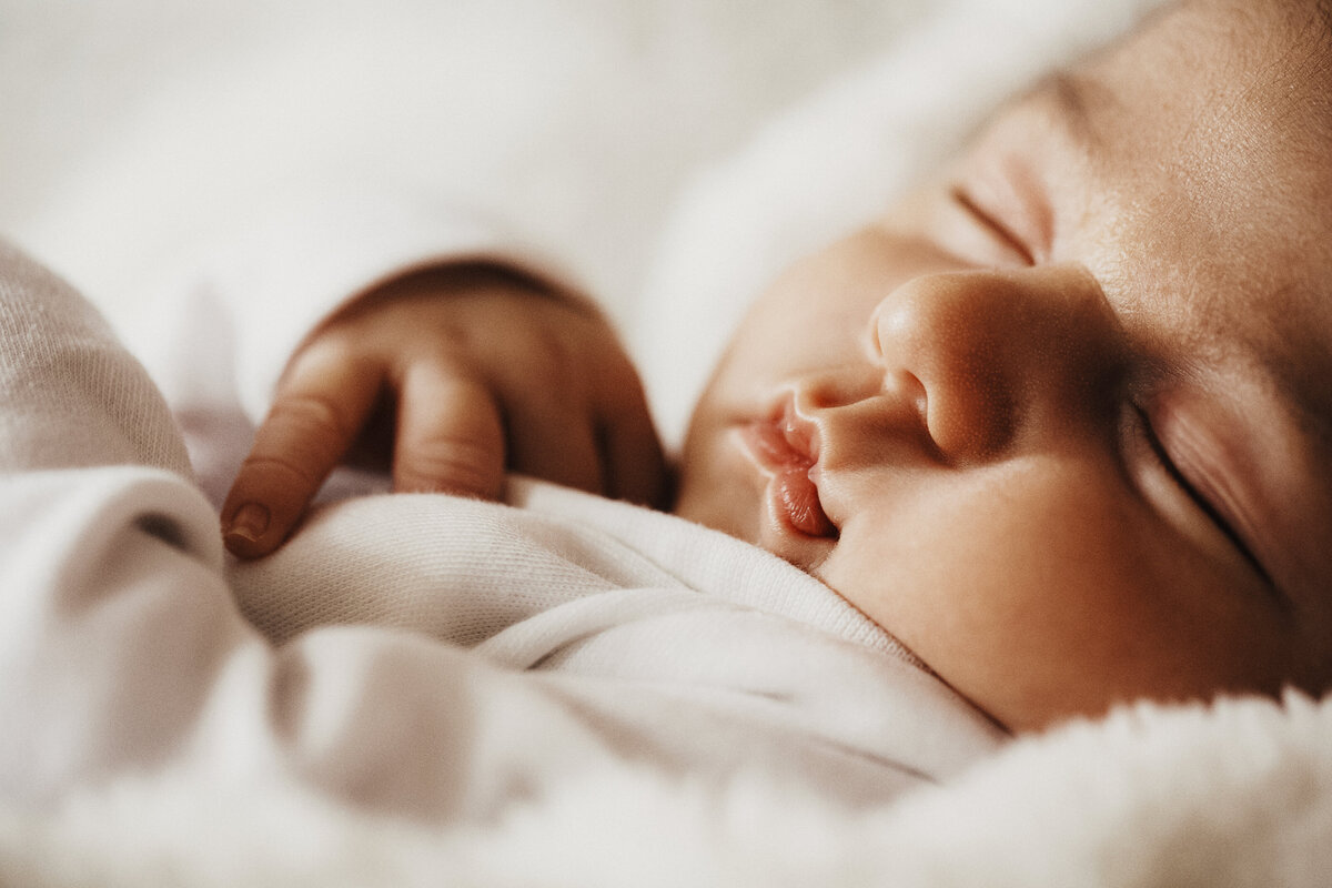 delicate close up of baby's mouth and hands