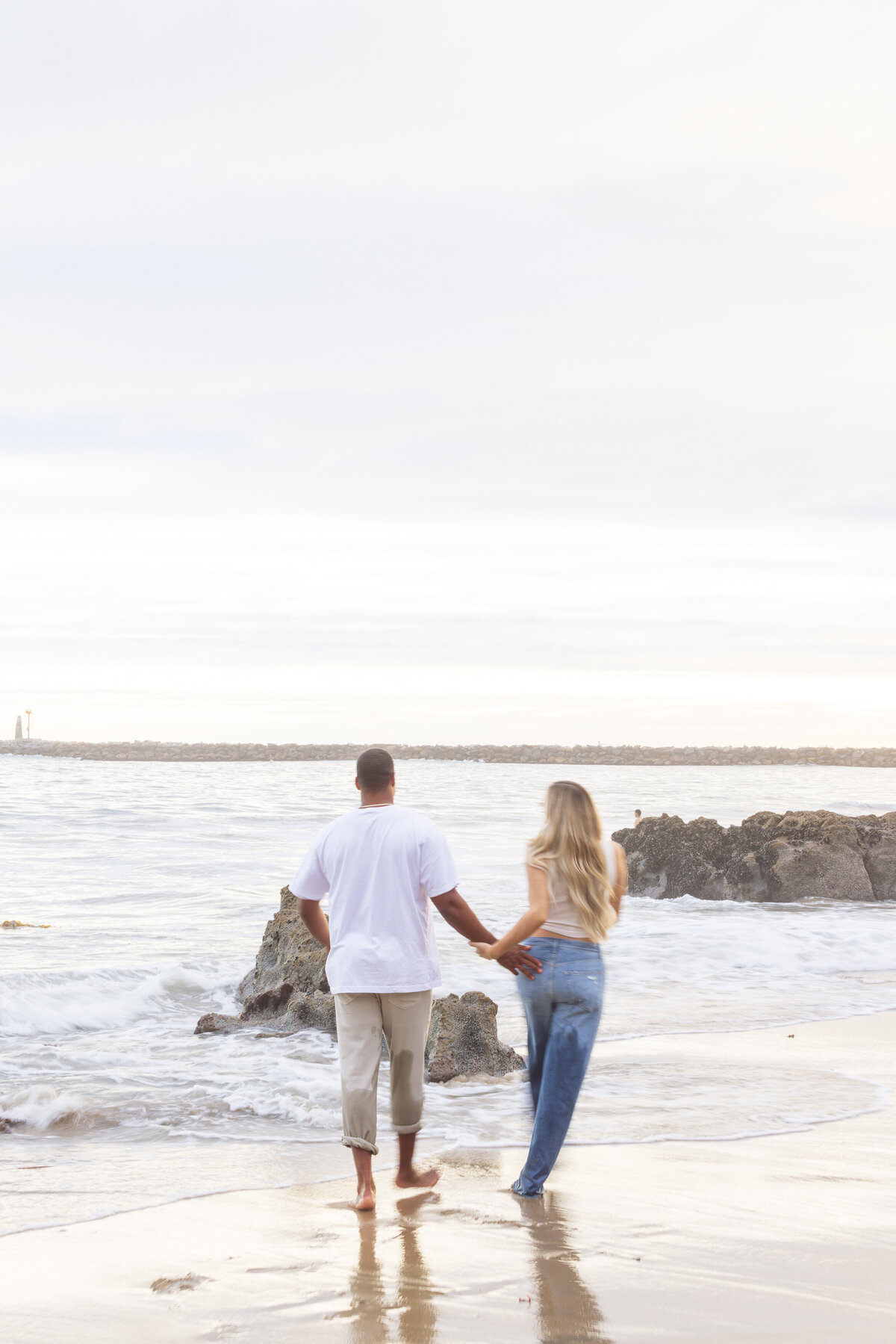 fun maternity photo of couple running