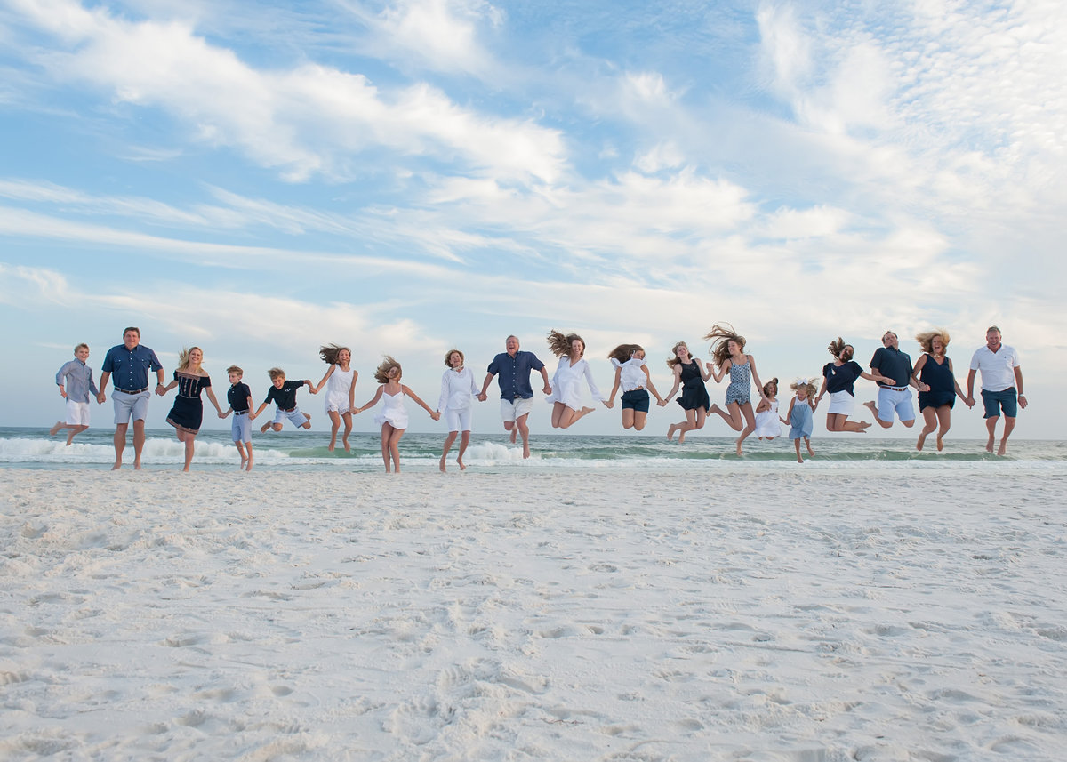 Whole family jumping by the water in Seaside Beach Florida