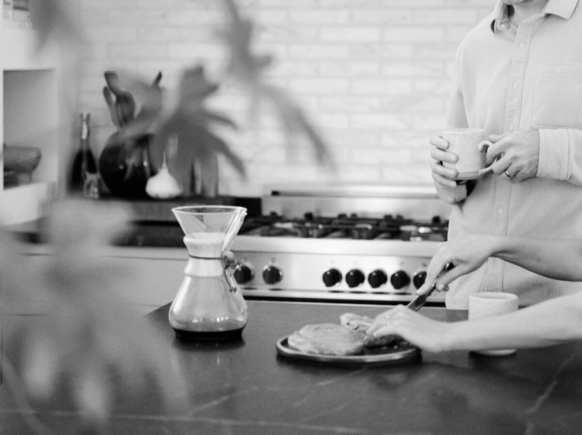 couple shares coffee and cinnamon rolls, fika at Fernhaus, Northern Michigan, lifestyle designer, interior photography
