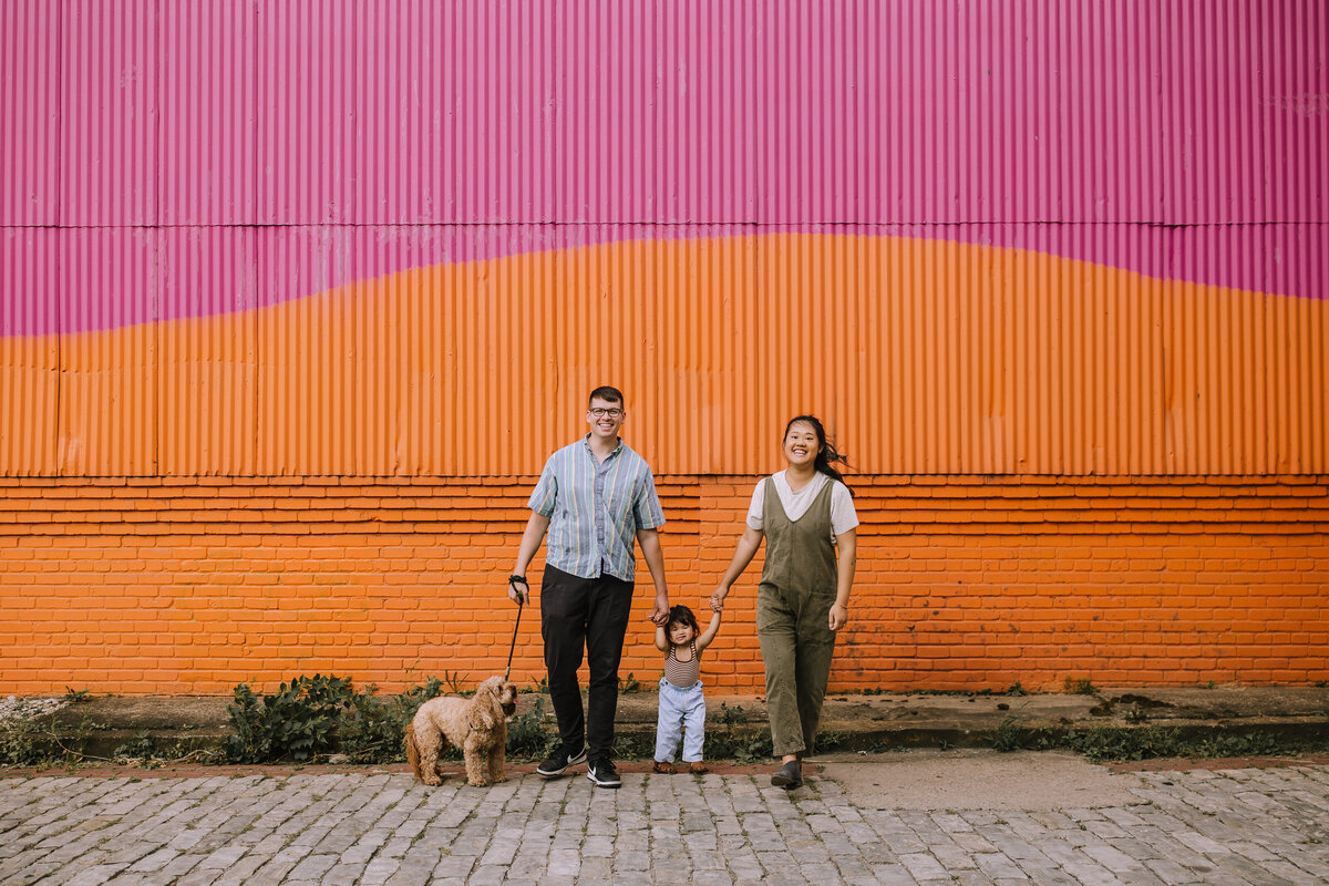 Family of three with a toddler and a dog at The Highline. 