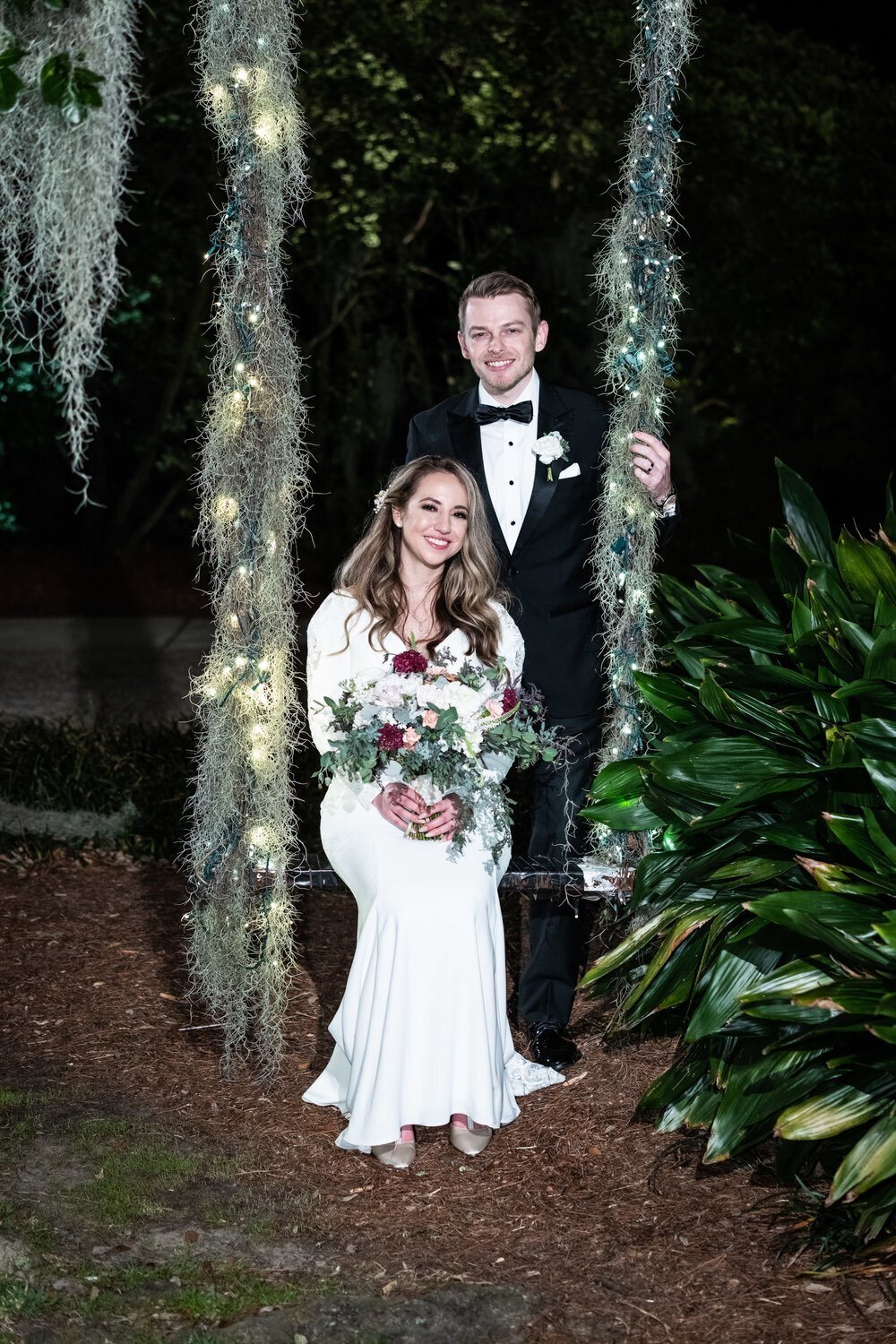 Bride and groom on tree swing at Southern Oaks