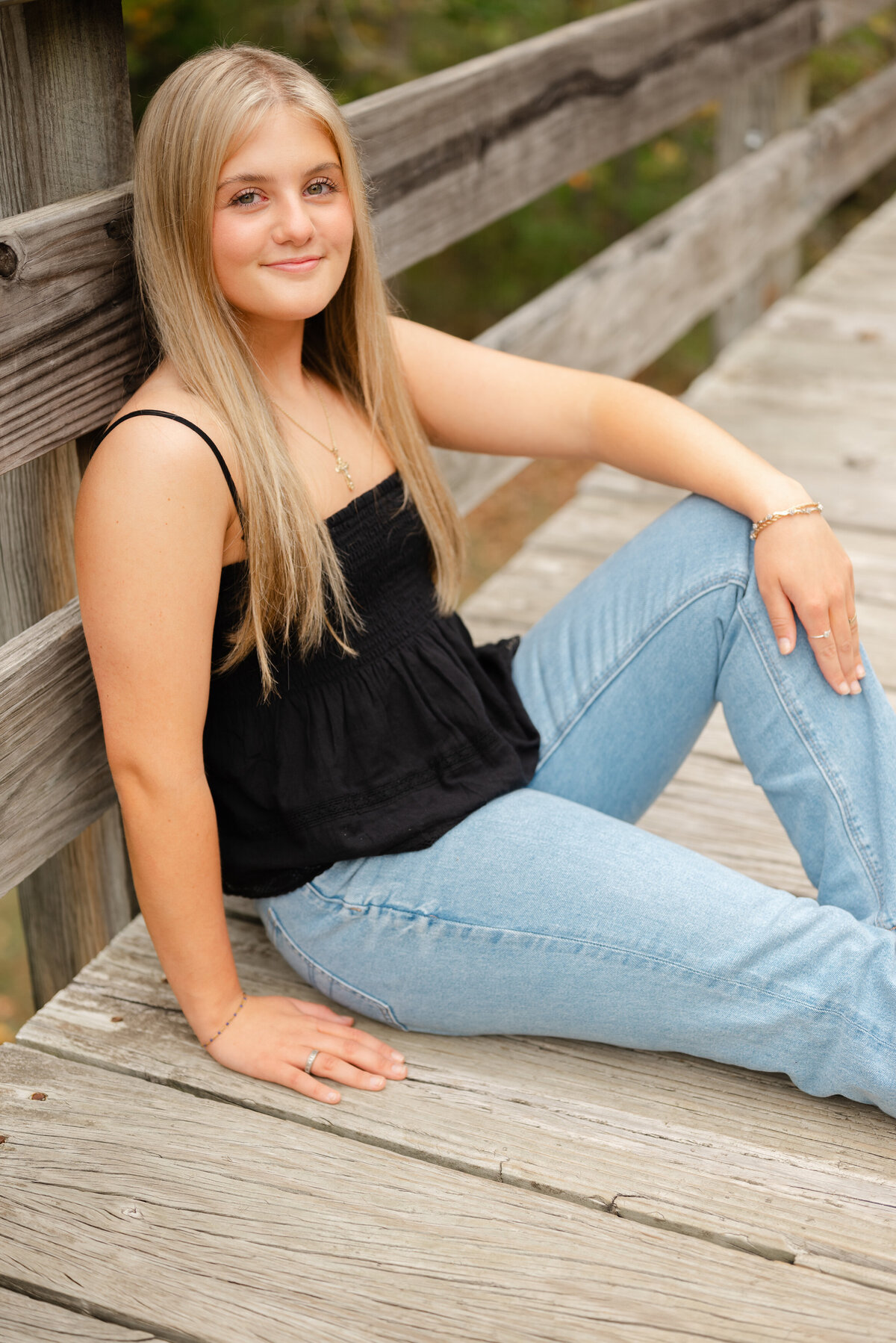 smiling-girl-sitting-on-bridge