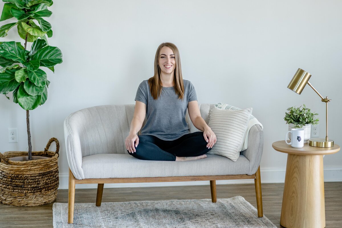 girl posing on couch hands crossed