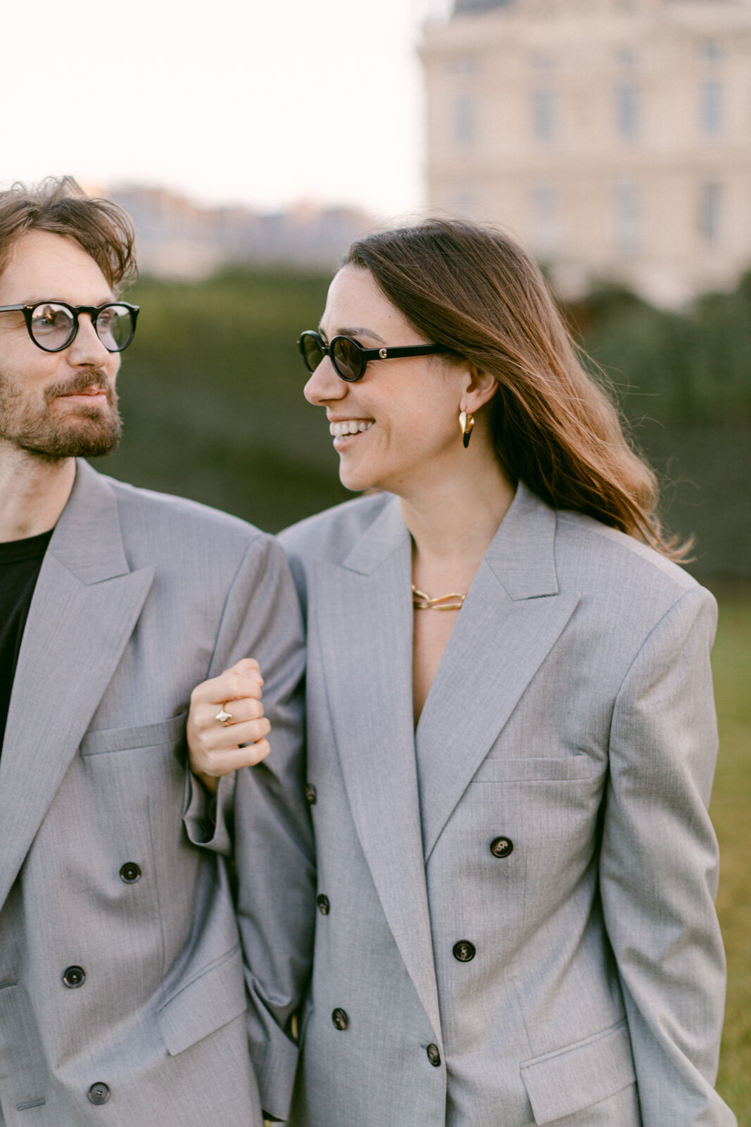 Engagement session at the Tuileries and Louvre in Paris, with a couple walking through the gardens under the morning light.