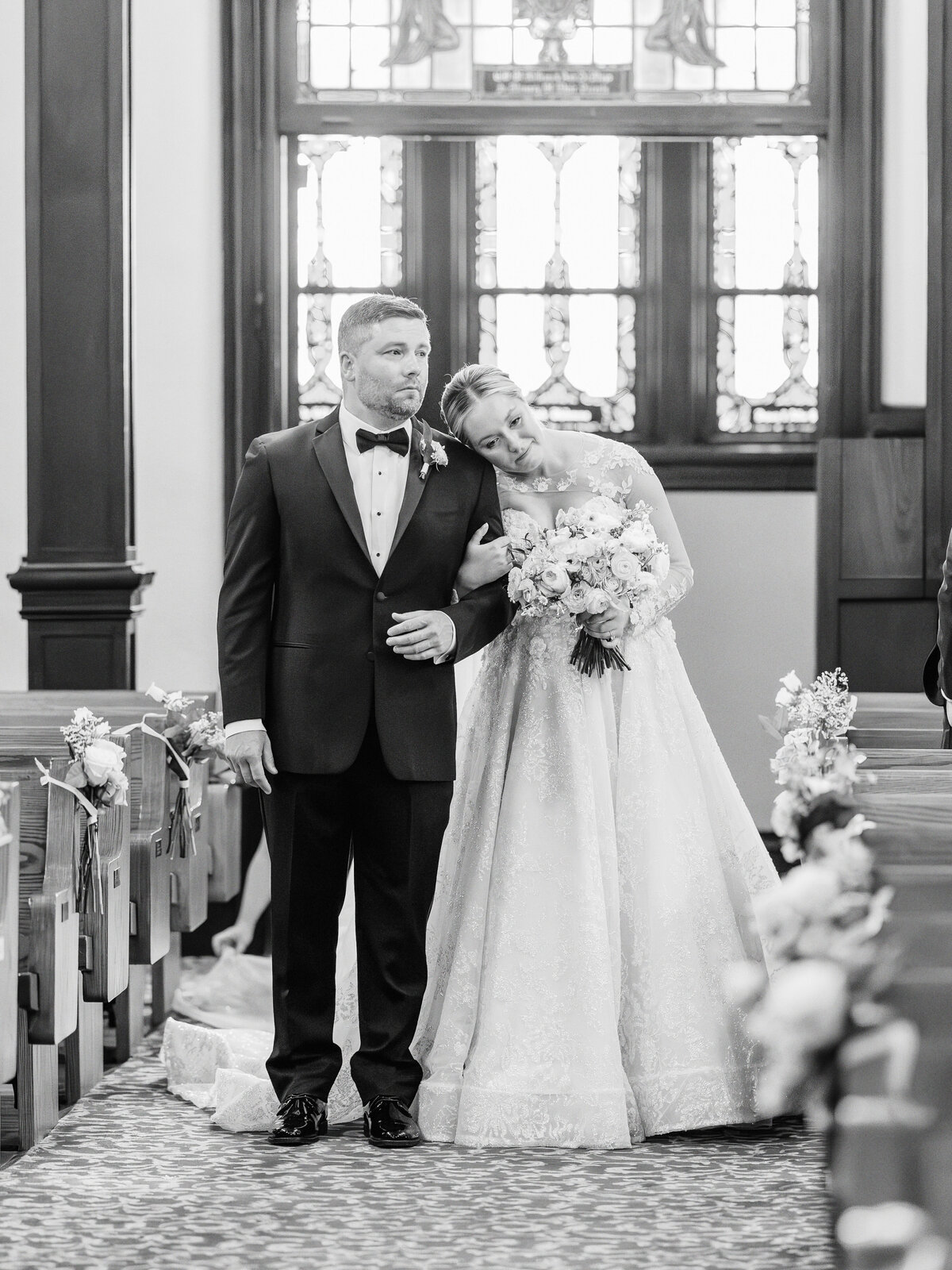 Bride and groom stand together, alone, in the sanctuary after Catholic wedding Mass