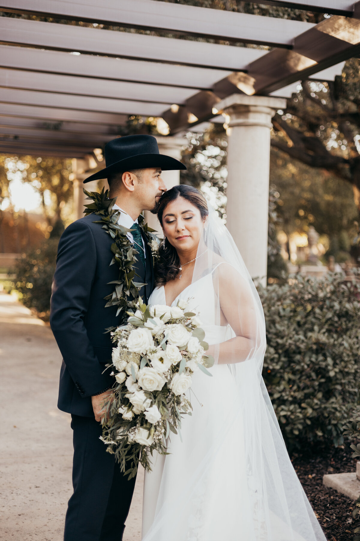 Looking at the bride and groom in their wedding attire out in this garden of flowers is just amazing.