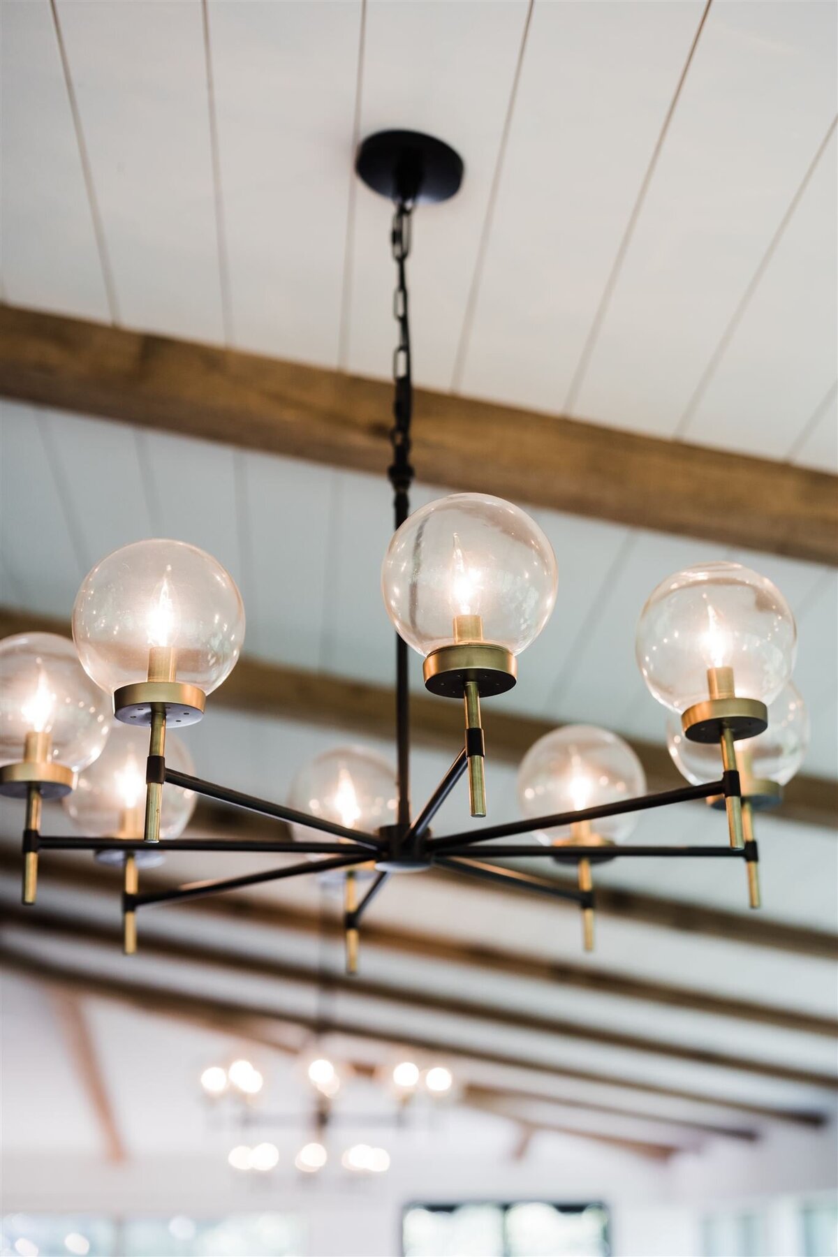 the elegant Pottery Barn chandeliers in the dining area of Willowbrook Wedding venue