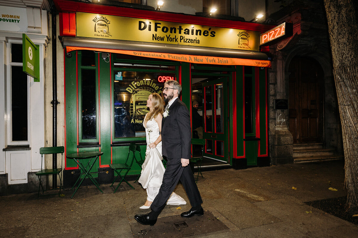Bride and groom walking outside of DiFontaine's in Dublin, Ireland