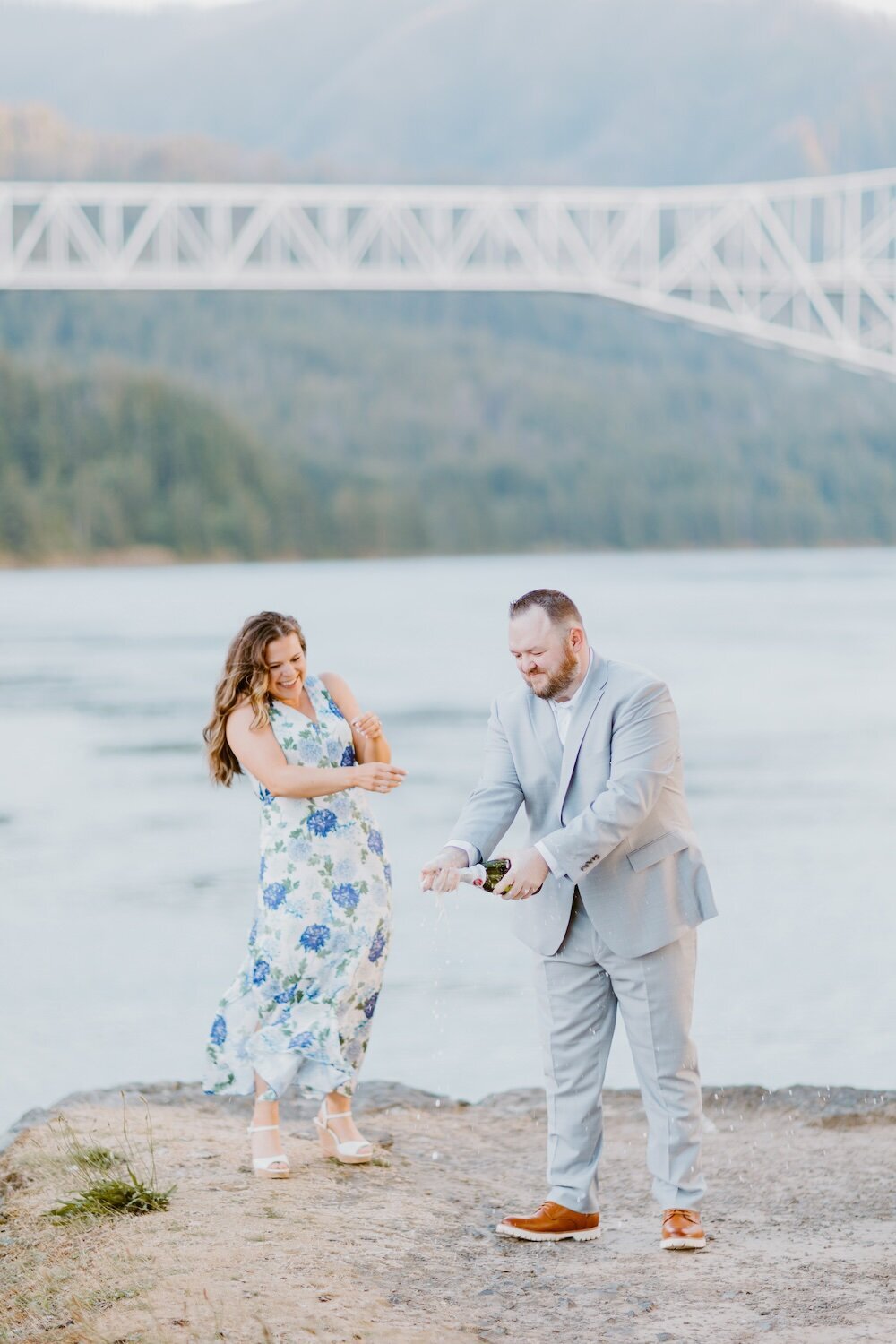 A Champagne pop image from Portland Engagement Photographers  on a river