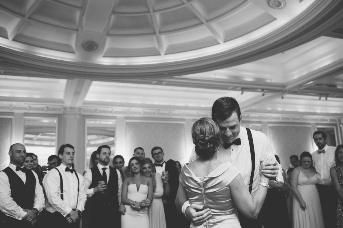 black and white photo of groom dancing with mom during wedding reception at The Muttontown Club
