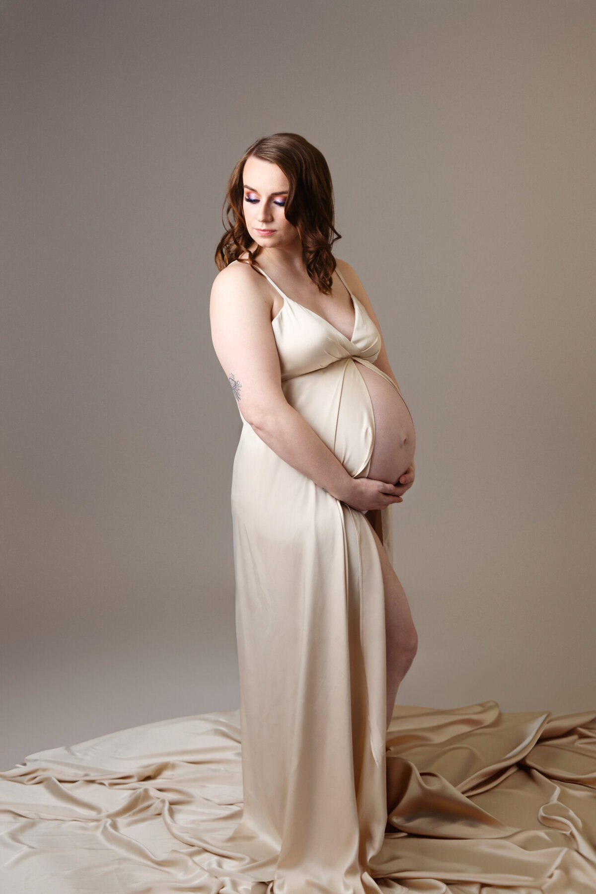 Pregnancy session of mother to be wearing a gold dress