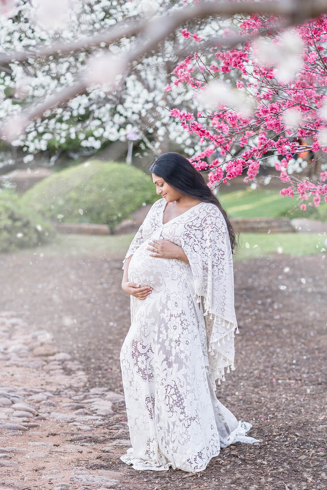 Celebrate impending motherhood with a mum adorned in 'We Are Reclamation' at Brisbane's Japanese garden, cherishing maternity bliss