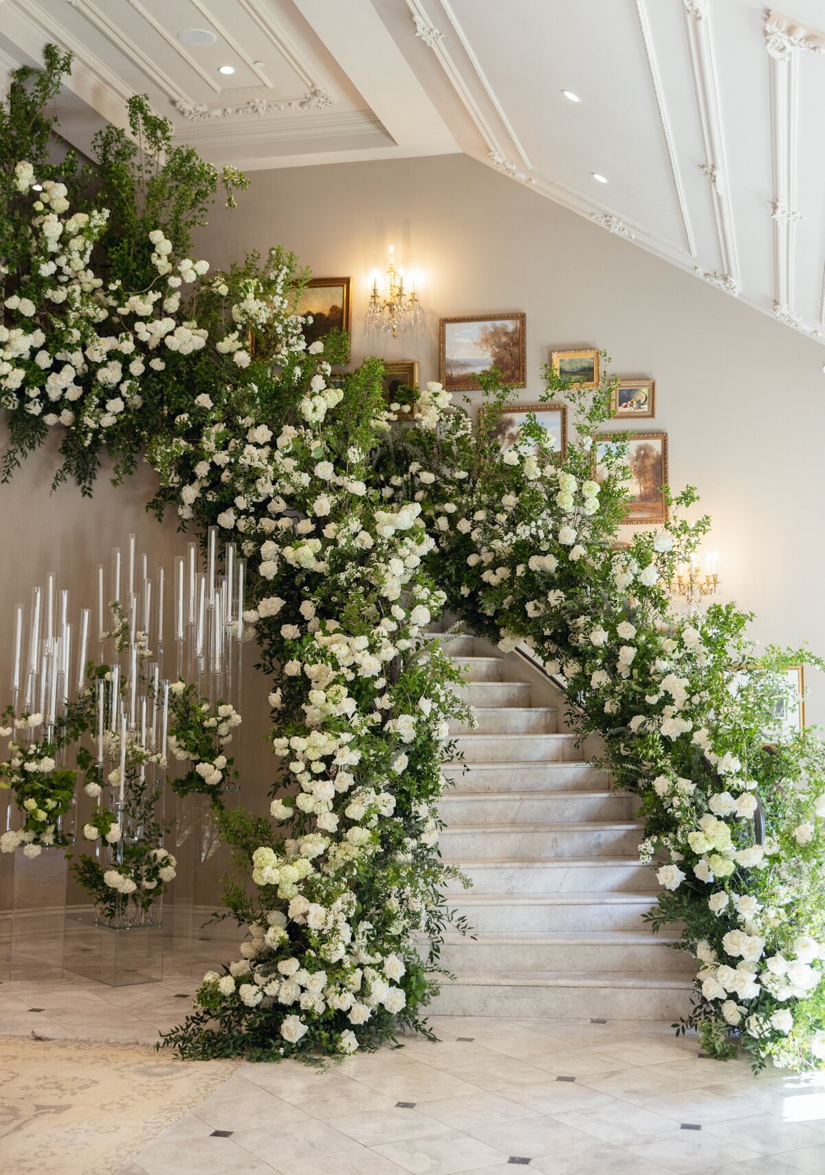Bride and groom walking down the flower-lined garden staircase at Park Château in East Brunswick NJ