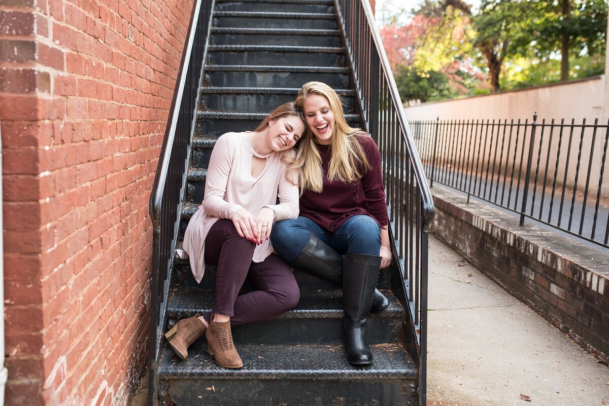 two sisters sitting on steps laughing