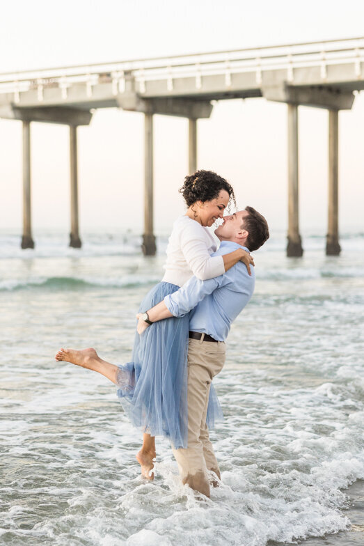 couple at the Scripps Pier San Diego engagement