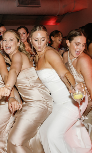 Close-up of wedding guests toasting with crystal glasses at Baker's Cay, captured by Claudia Amalia, a wedding photographer in Miami.