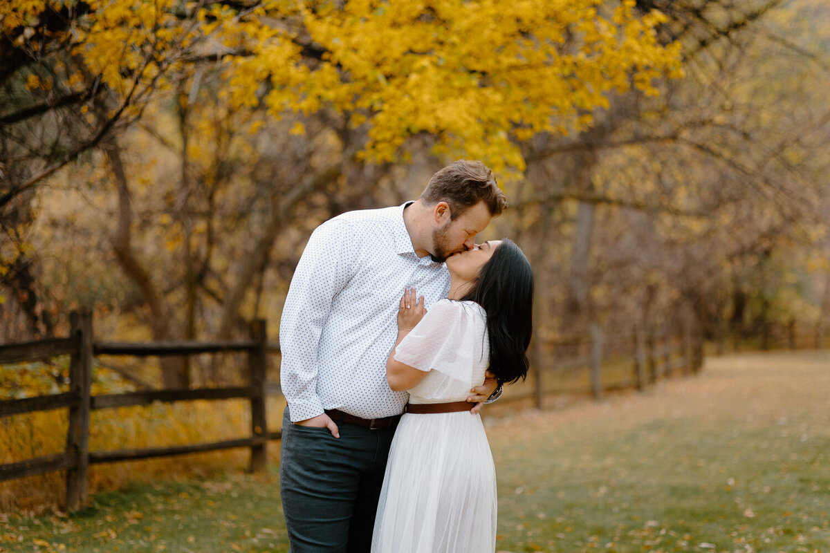 A couple kisses during their engagement session in Fort Collins, Colorado.