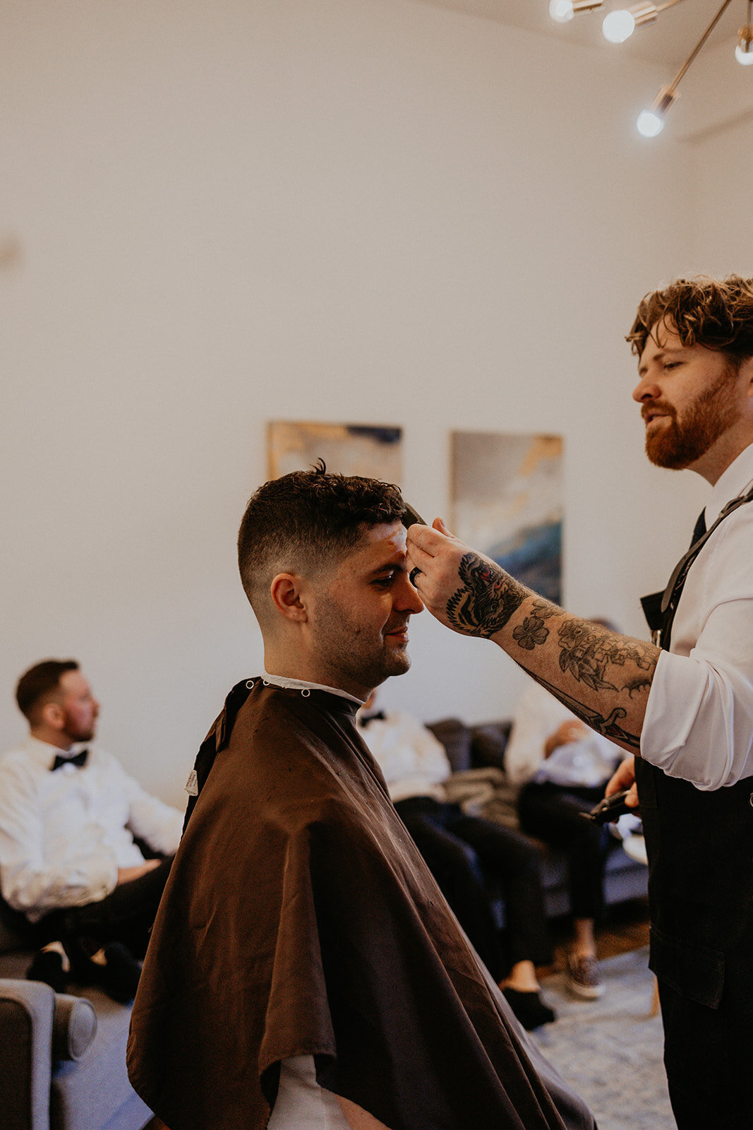 groom and his barber getting ready for his wedding