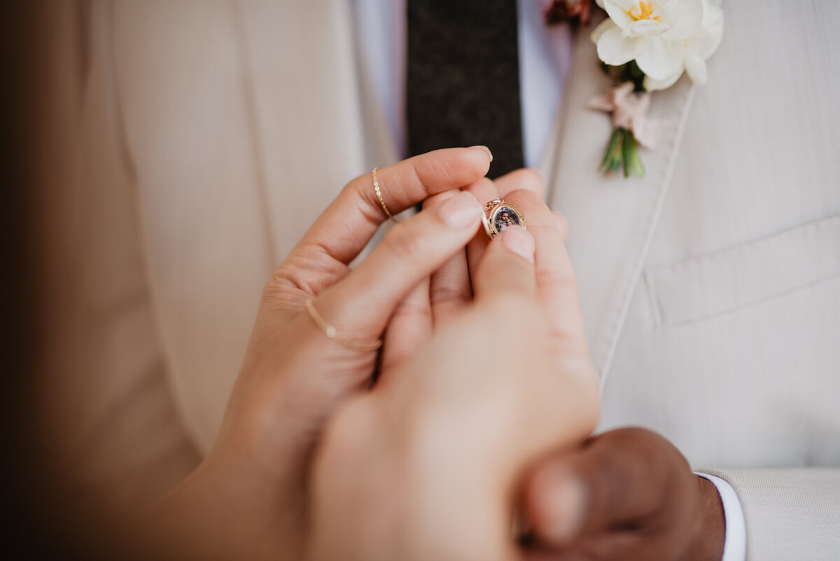 Utah Elopement Photographer captures bride holding necklace