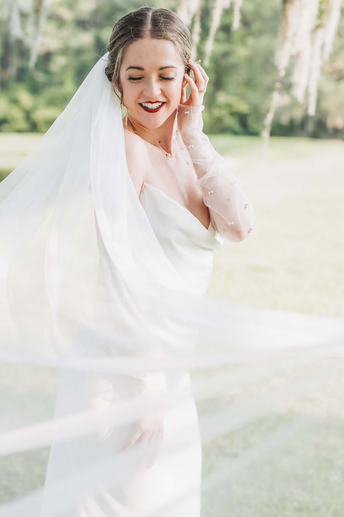 Bride smiling under spanish moss