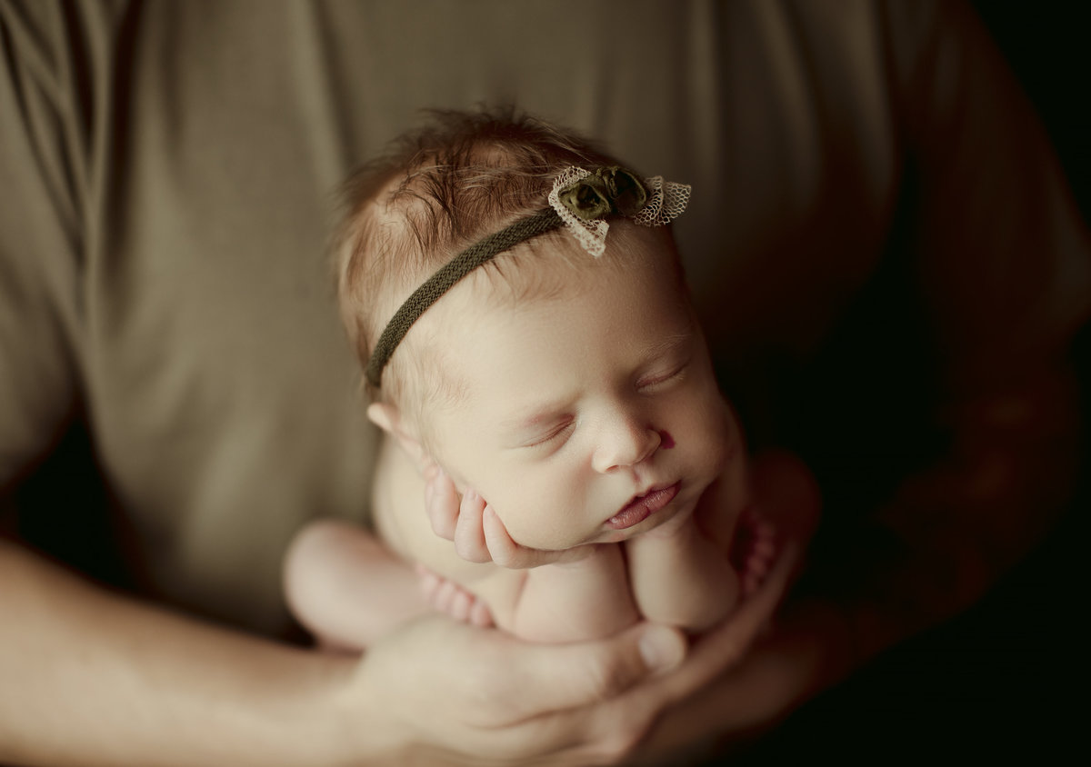 Classic newborn photography featuring minimalist styling and soft tones