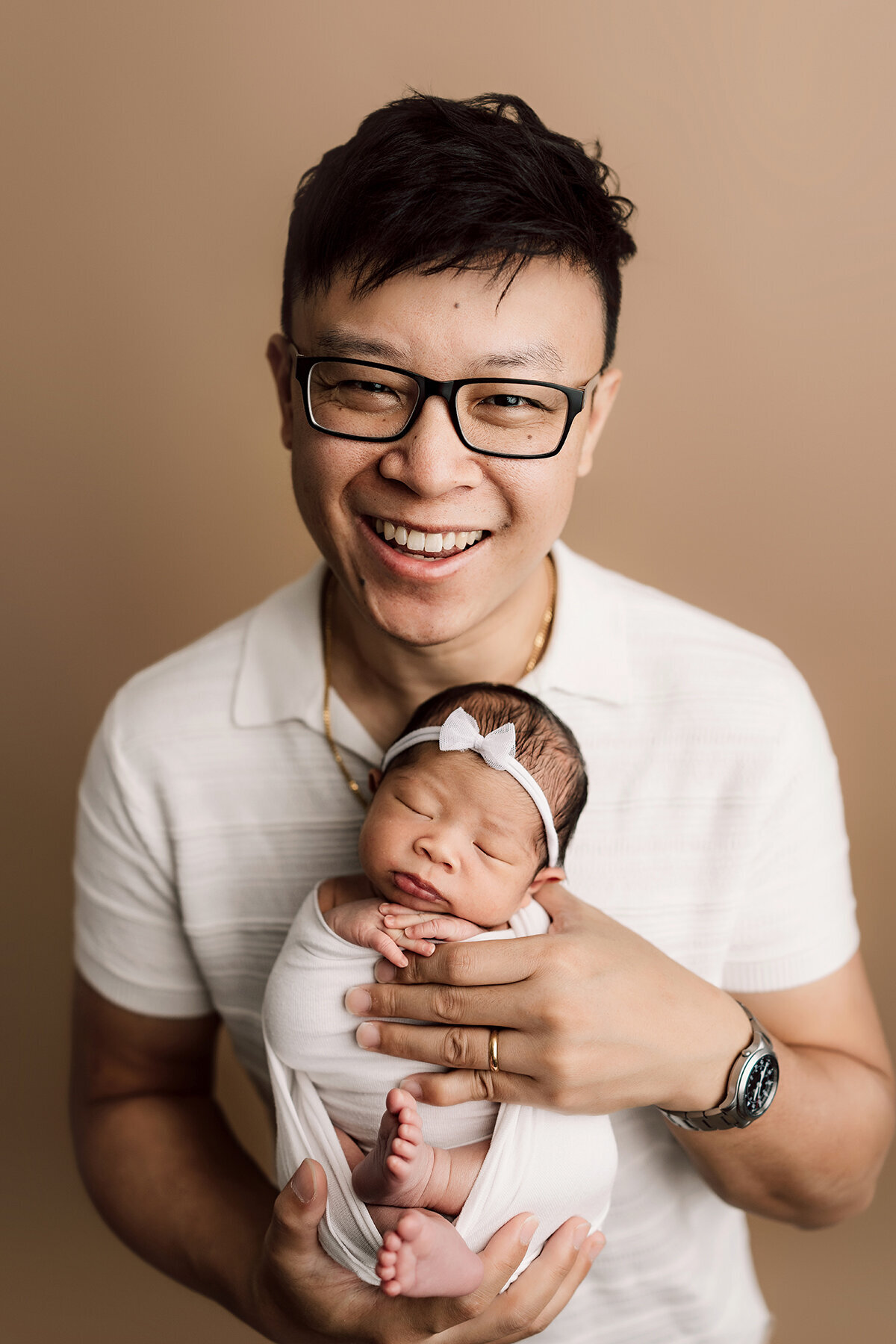 Colorado newborn photoshoot holding baby girl