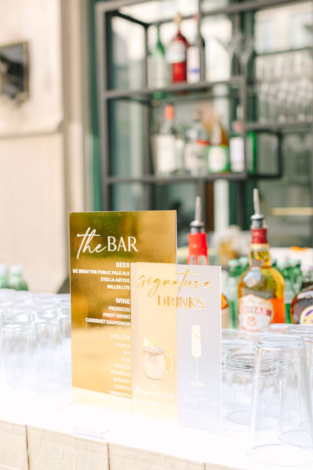 Gold bar and signature drinks sign at wedding bar