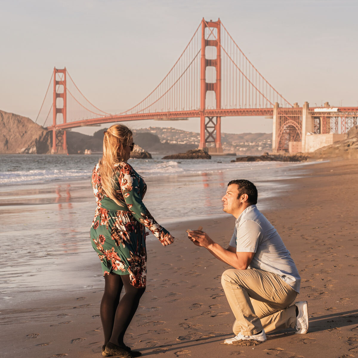 Romantic moment during the sunset for a proposal at Baker Beach in San Francisco. Photo by 4Karma Studio