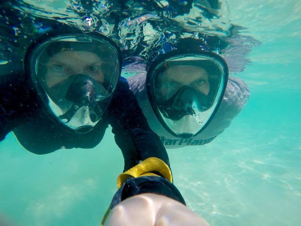 selfie of Karen and her husband snorkeling with full face masks in Turks and Caicos