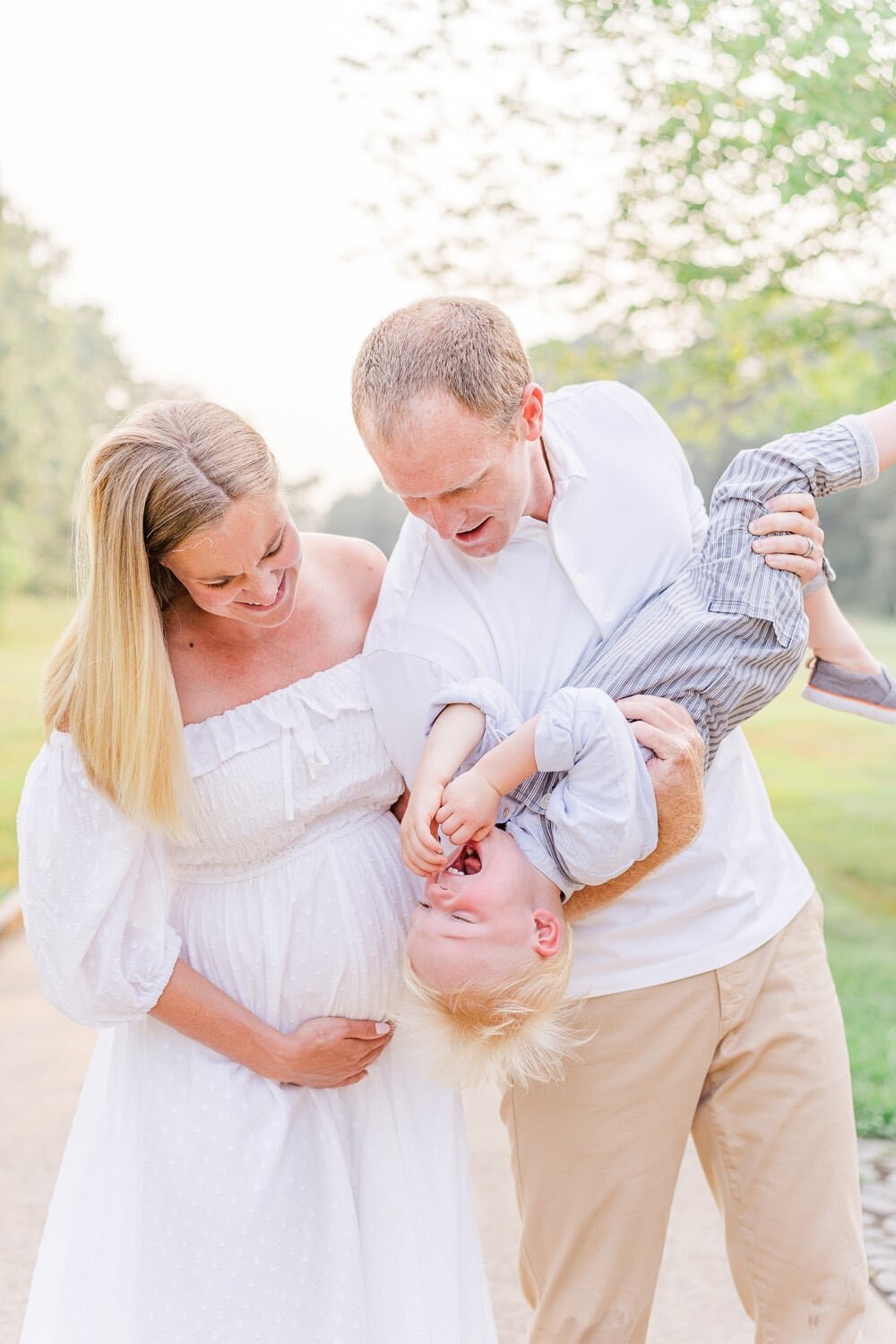 expecting parents playing with older brother during Northern VA maternity photos