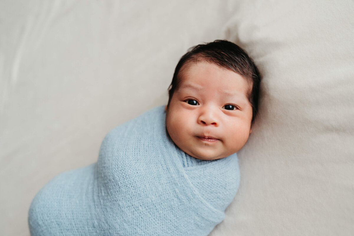 newborn-session-with-blue-swaddle