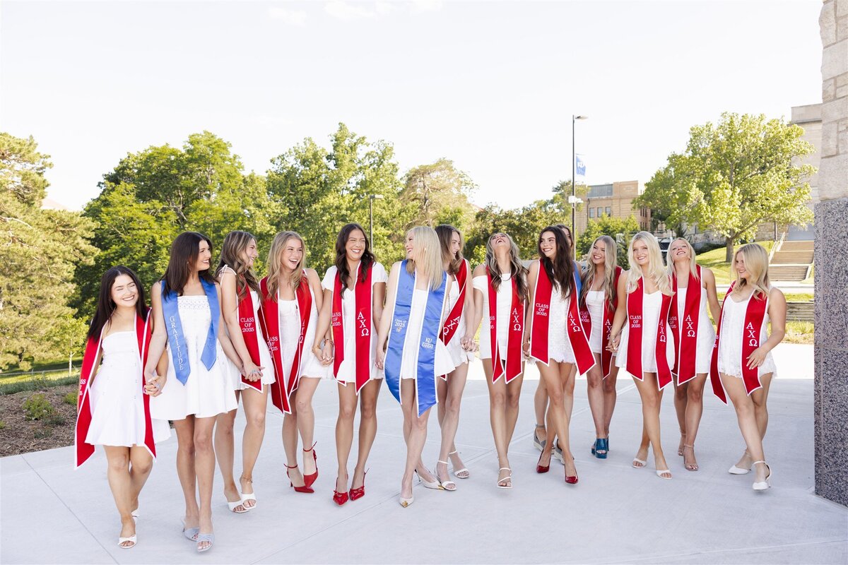 Cap and gown photos in front of Capitol Federal Hall at KU